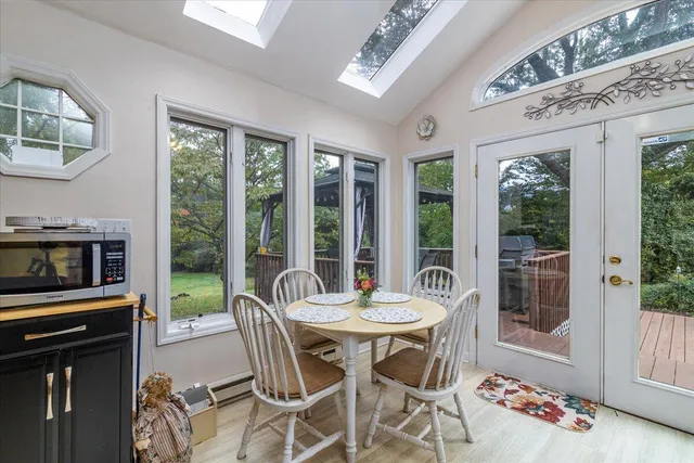 a view of porch with a table and chairs