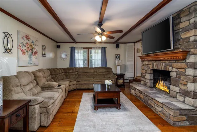 a living room with furniture a flat screen tv and a fireplace