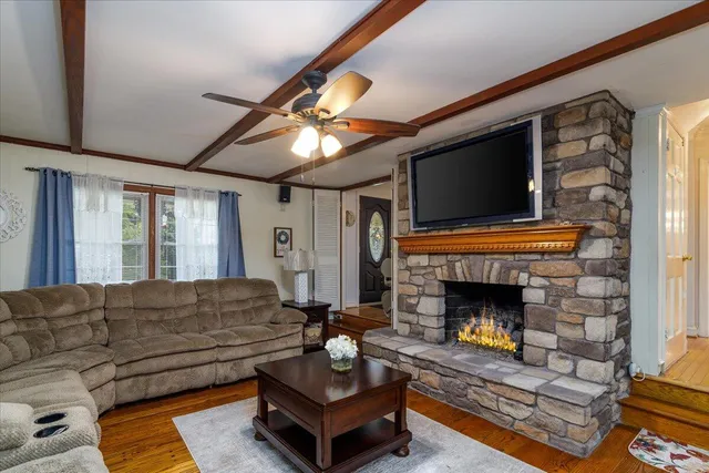 a view of a livingroom with furniture and staircase