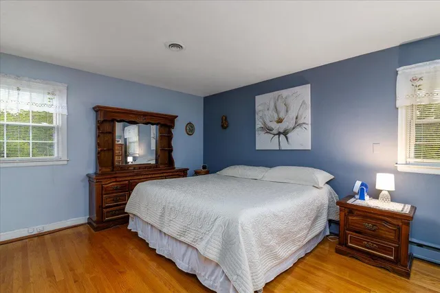 a bedroom with furniture and a flat screen tv