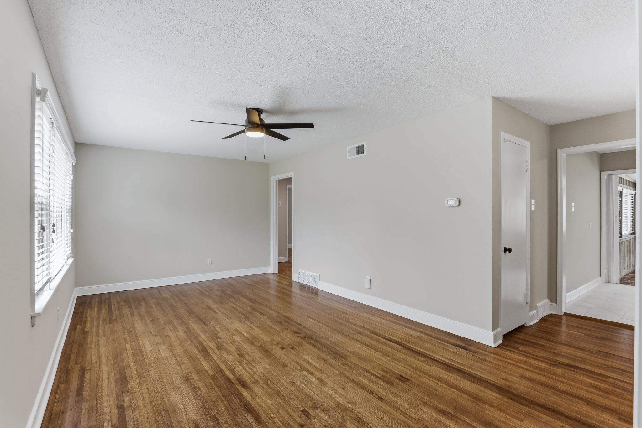 312 Fernway Road Memphis, TN 38117 - Photo 10 of 38 Spare room featuring dark wood-type flooring, a textured ceiling, and ceiling fan