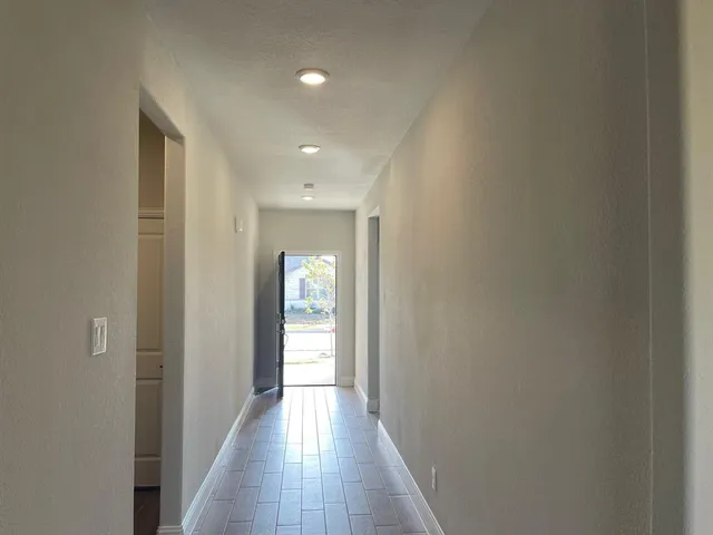 a view of hallway with wooden floor