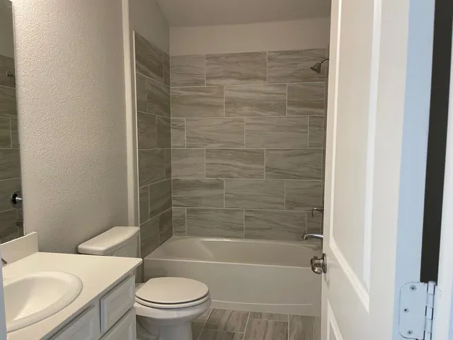 a bathroom with a toilet and a bathtub