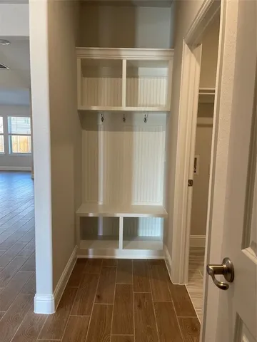 a view of walk in closet with empty racks
