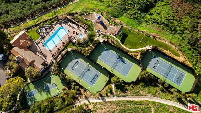 a view of a backyard with potted plants and water fountain