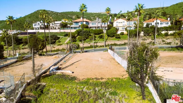 an aerial view of a house with a garden and swimming pool