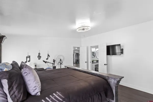 a bed room with a bed and a television