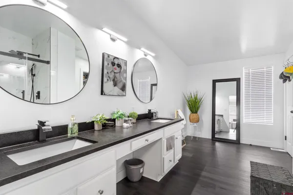 a spacious bathroom with a double vanity sink and a mirror
