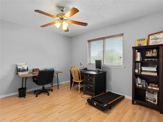 a view of workspace with wooden floor and gym equipment