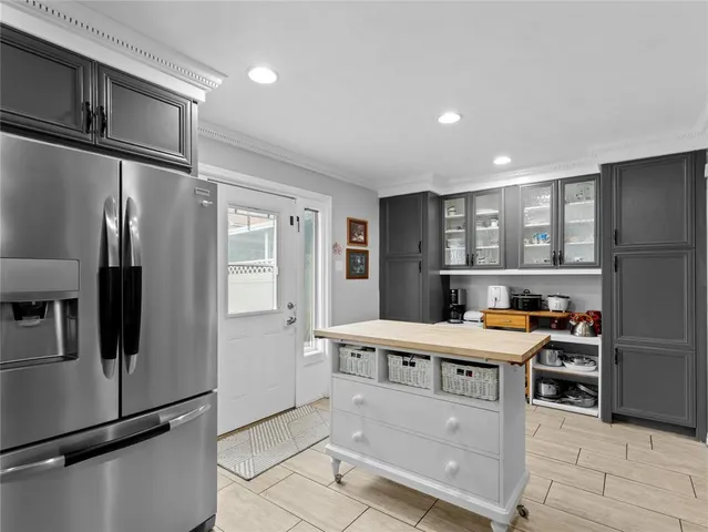 a kitchen with stainless steel appliances granite countertop a refrigerator and a stove