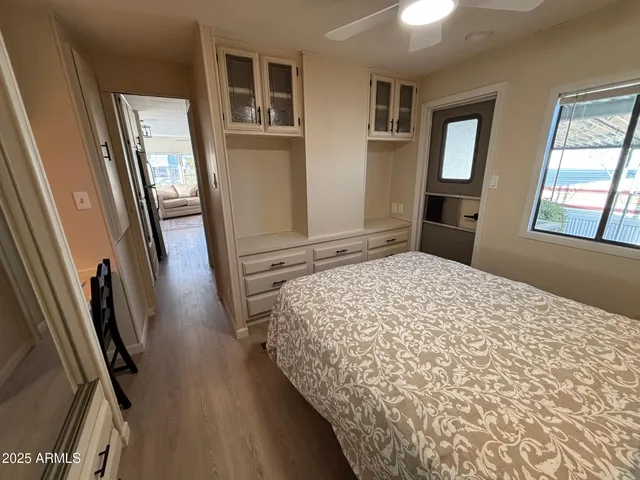 a bedroom with a bed and wooden floor