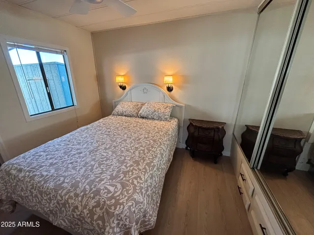a bedroom with a bed and a view of living room