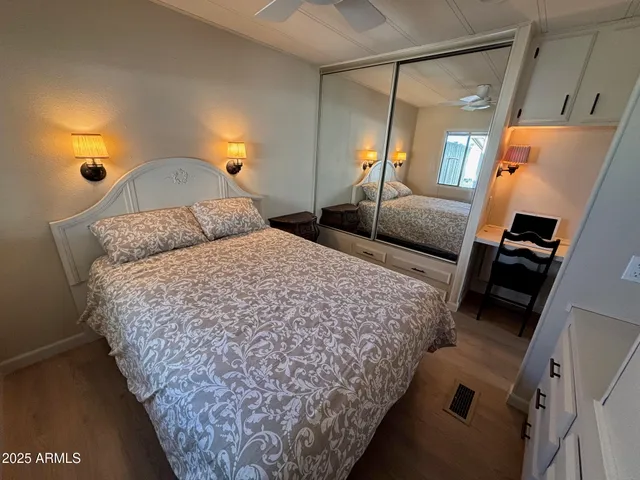 a bedroom with bed and a night stand