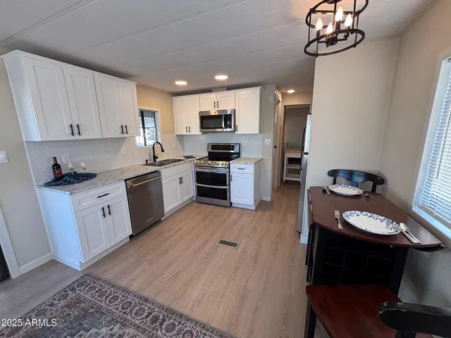 a kitchen with stainless steel appliances kitchen island granite countertop a stove a sink and a microwave