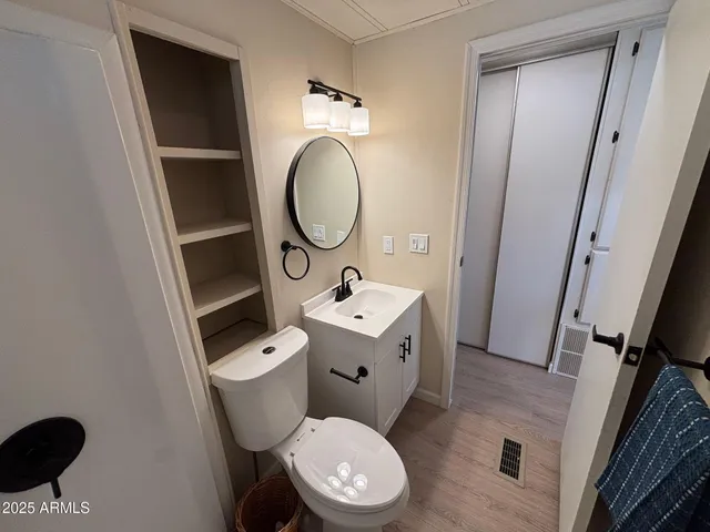 a white toilet sitting next to a bathroom sink