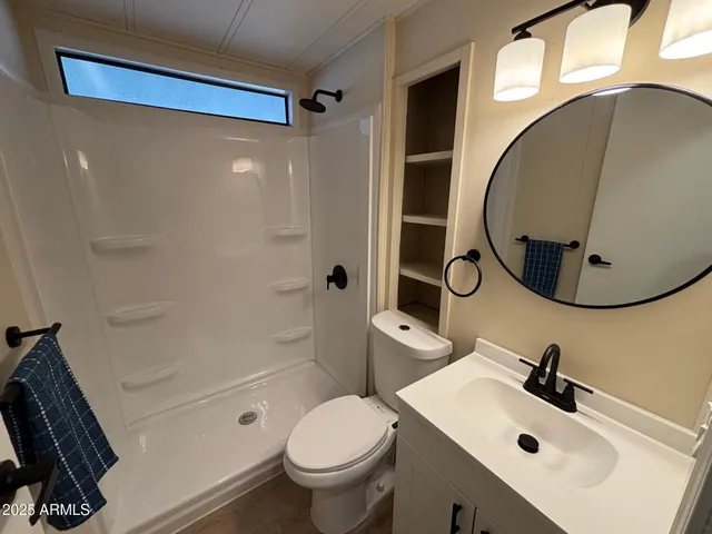 a bathroom with a sink toilet and shower