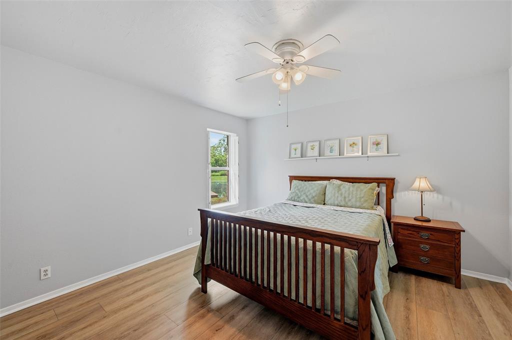 522 High Country Road Sherman, TX 75092 - Photo 15 of 38 a bedroom with a bed and wooden floor