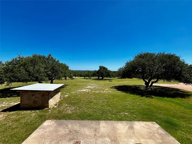 a view of a swimming pool with a yard