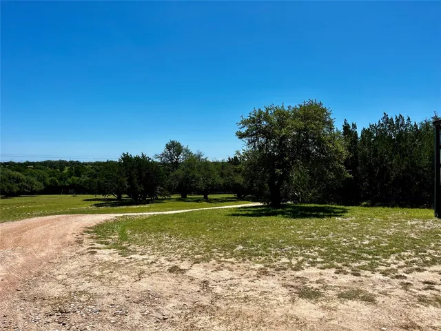 a view of a swimming pool with a yard
