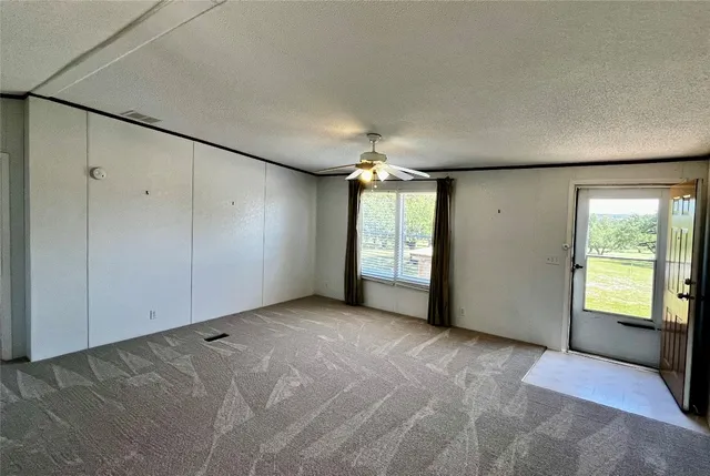 an empty room with windows and closet