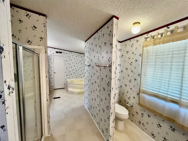 a bathroom with a toilet sink and shower