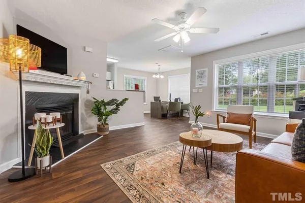 a living room with furniture a fireplace and a flat screen tv
