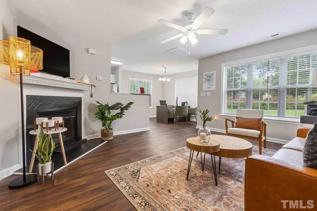 a living room with furniture a fireplace and a flat screen tv