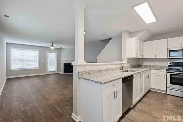 a kitchen with a sink stove and cabinets