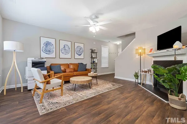 a living room with furniture and wooden floor
