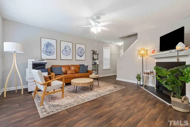 a living room with furniture and wooden floor