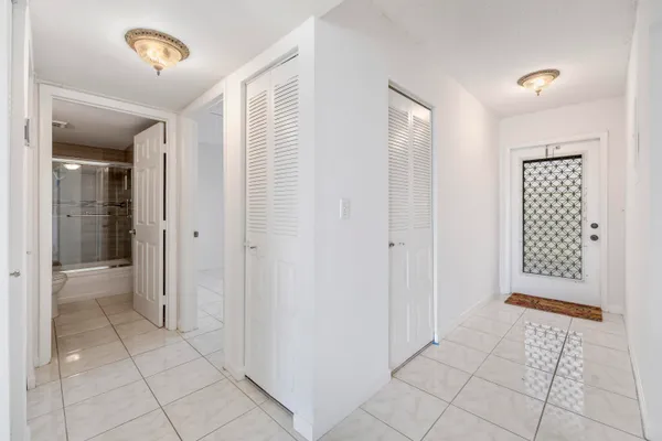 a view of a room that has a window and furniture