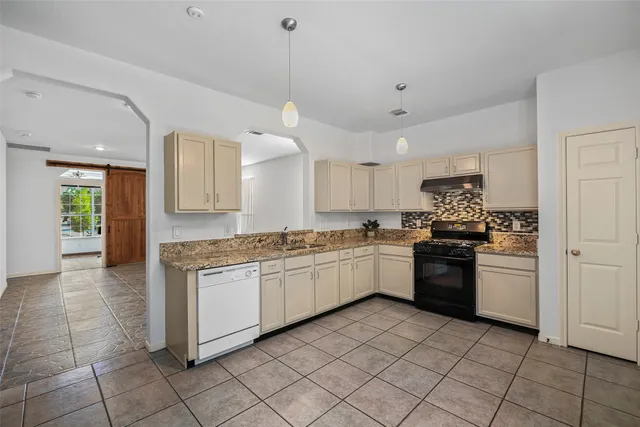 a kitchen with stainless steel appliances granite countertop a stove and a sink