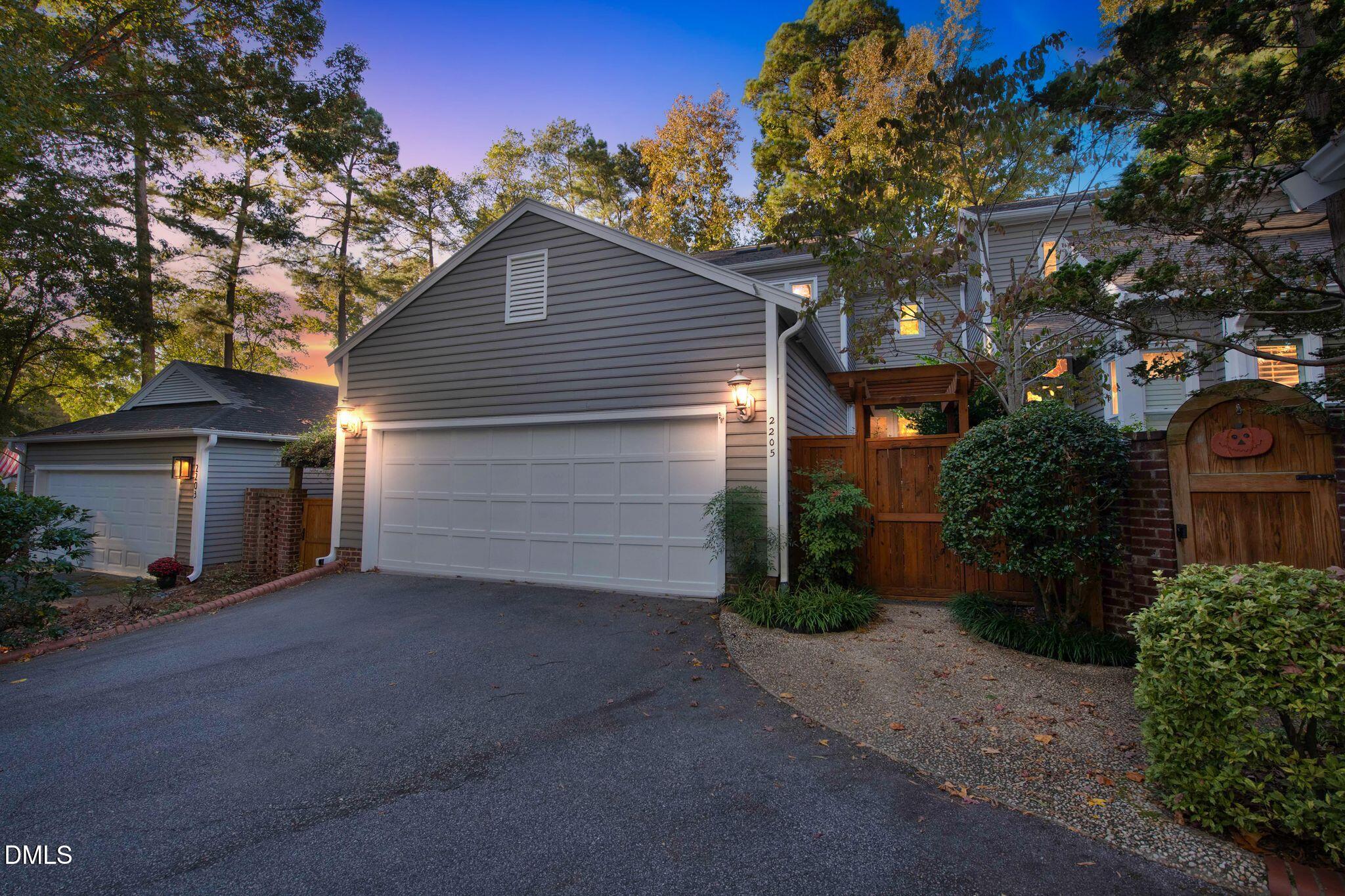 a view of a house with a yard and garage