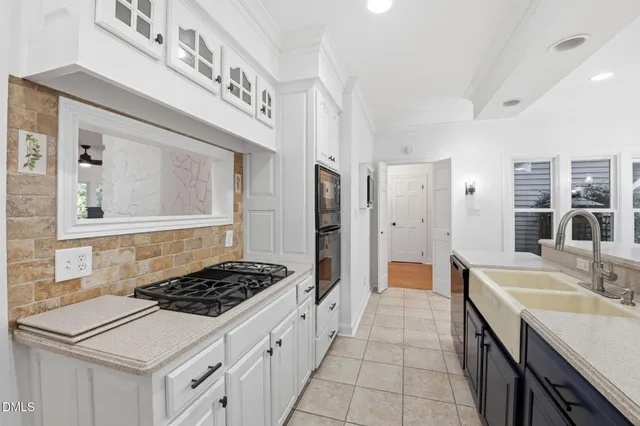 a kitchen with a stove a sink and a refrigerator