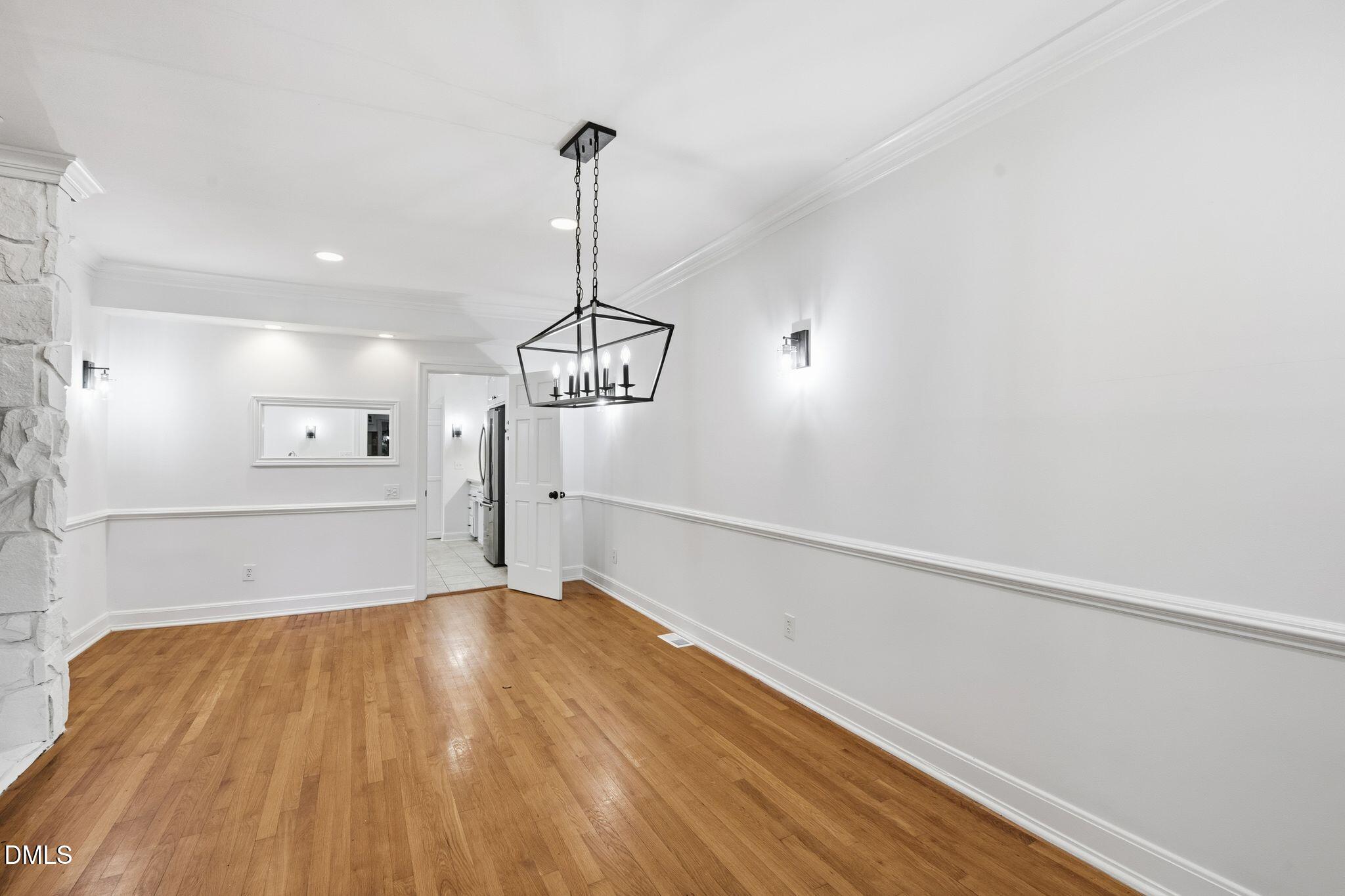 2205 Landings Way Raleigh, NC 27615 - Photo 13 of 35 a view of empty room with wooden floor