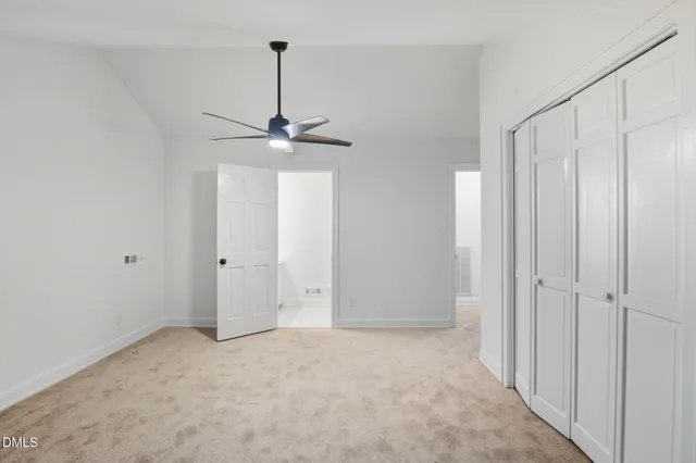 a view of an empty room with a ceiling fan