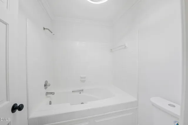a bathroom with a bathtub and toilet