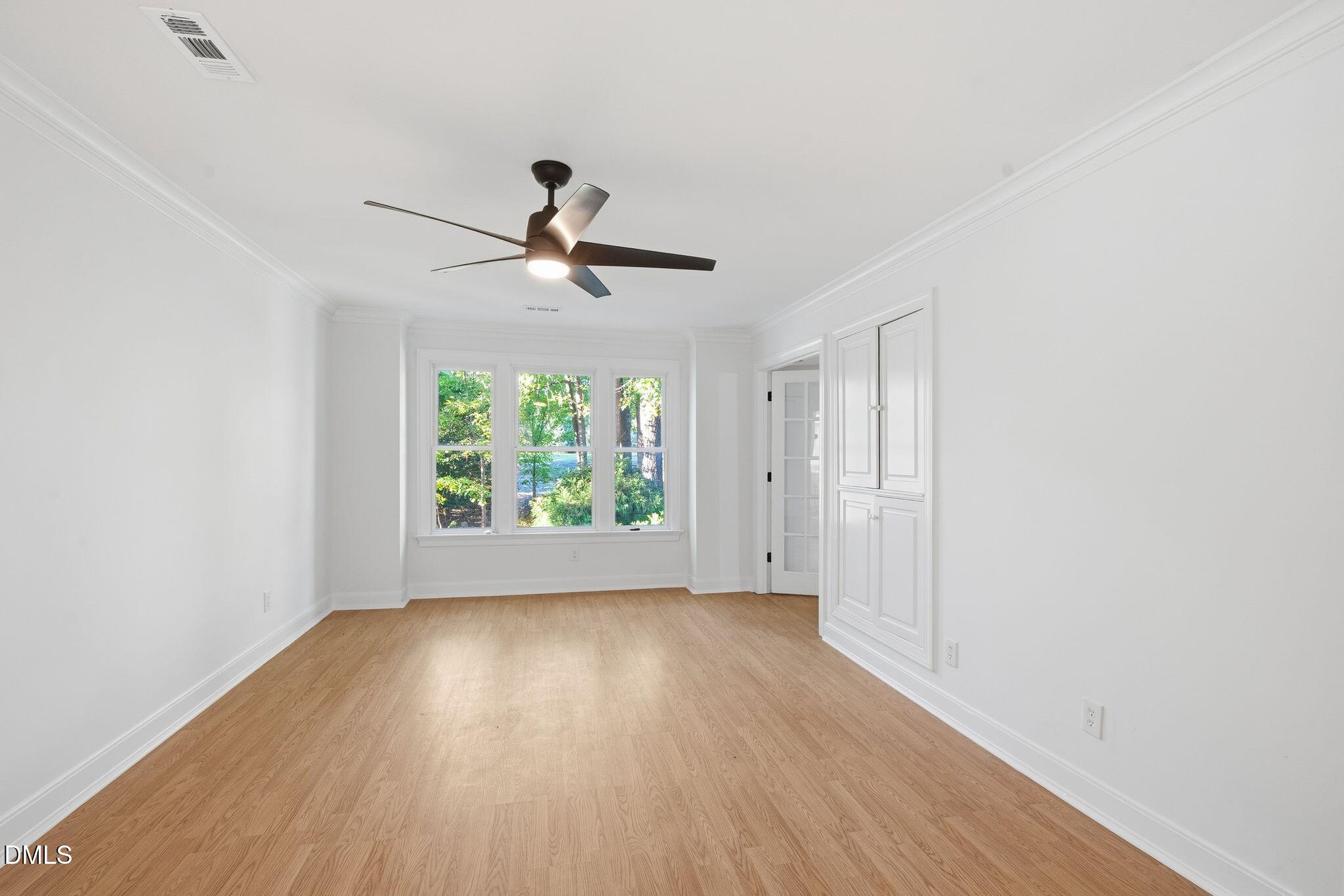 2205 Landings Way Raleigh, NC 27615 - Photo 21 of 35 a view of room with window ceiling fan and hardwood floor