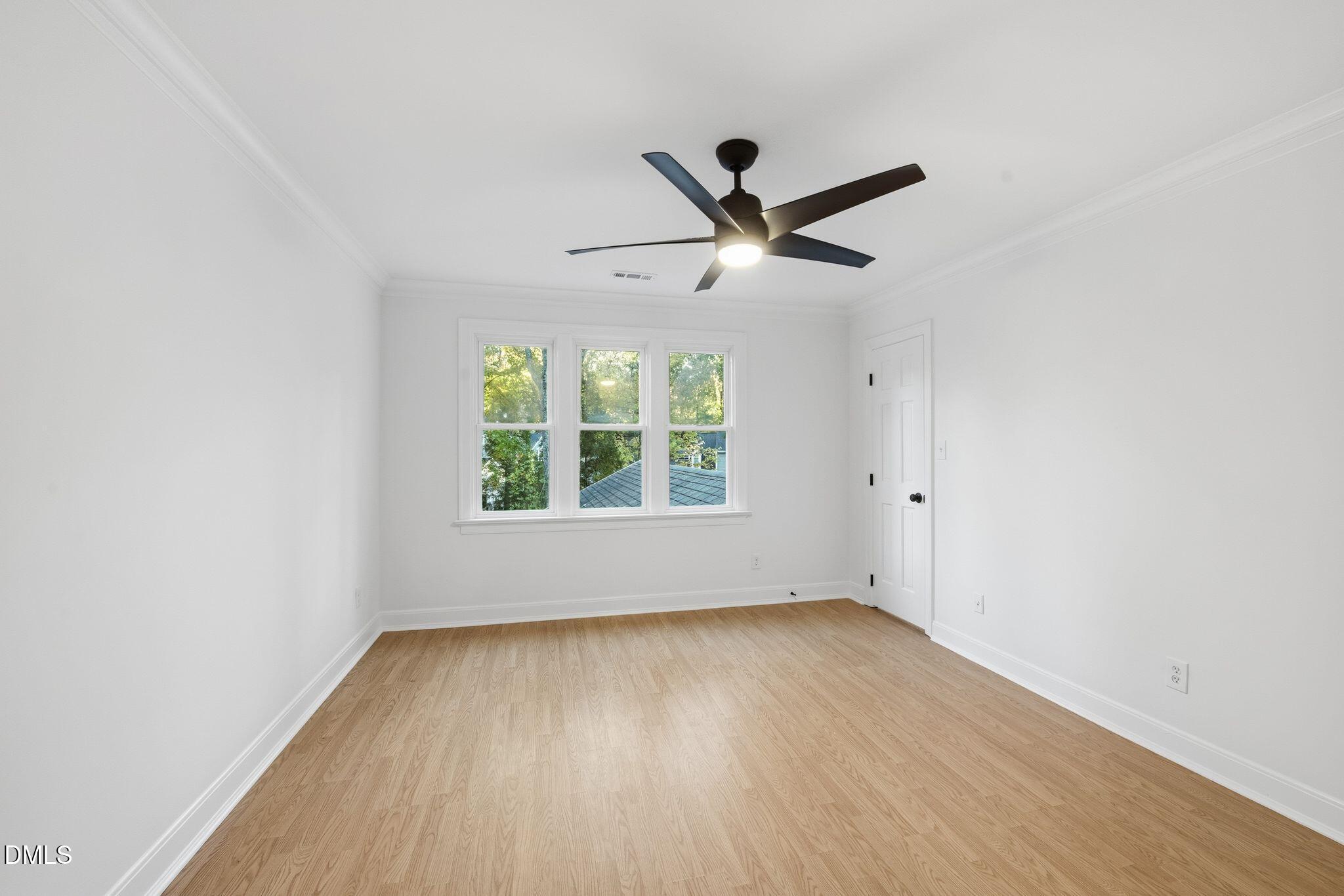 2205 Landings Way Raleigh, NC 27615 - Photo 23 of 35 an empty room with wooden floor and windows