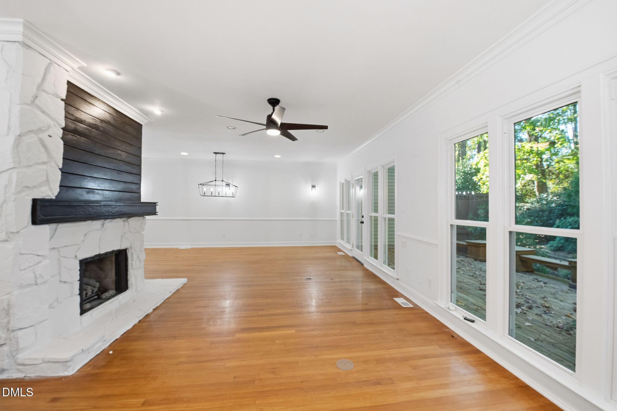 2205 Landings Way Raleigh, NC 27615 - Photo 5 of 35 a view of empty room with wooden floor and fireplace