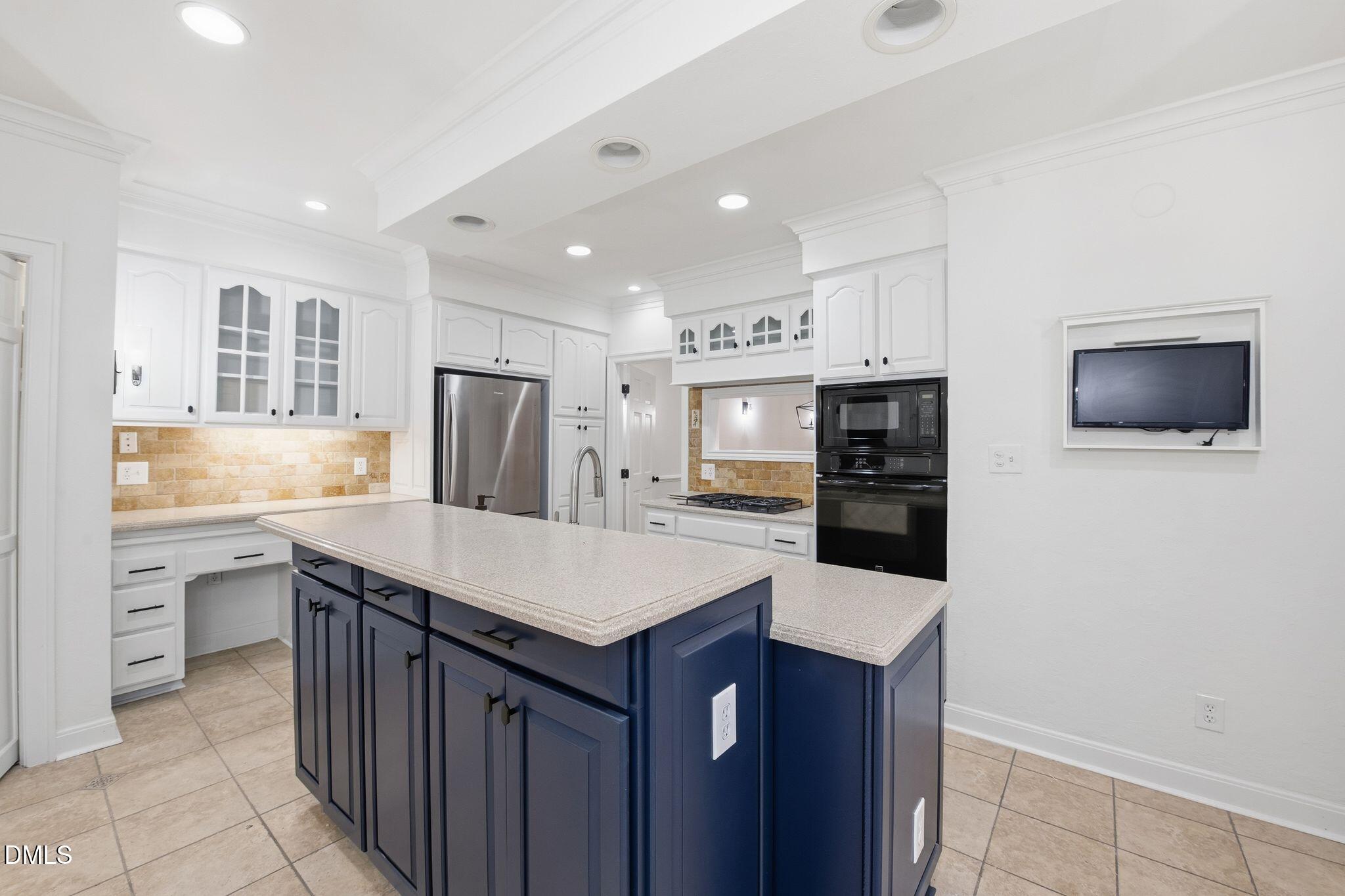 2205 Landings Way Raleigh, NC 27615 - Photo 7 of 35 a kitchen with stainless steel appliances a refrigerator and a stove top oven