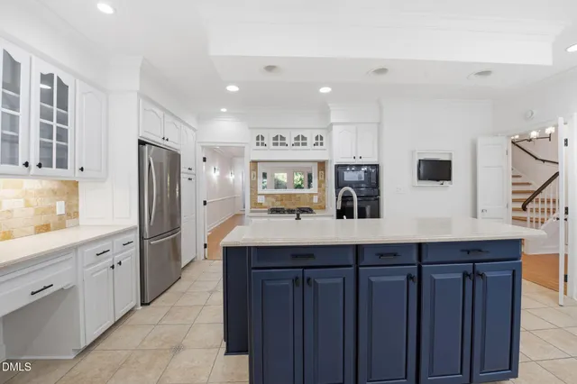 a kitchen with stainless steel appliances a sink and a refrigerator