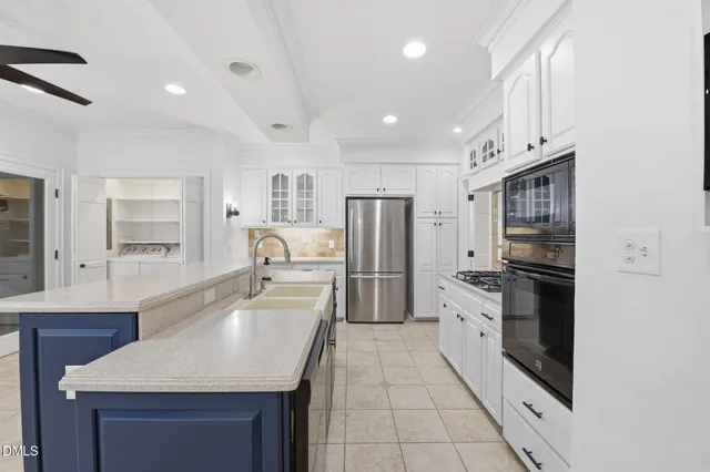 a kitchen with refrigerator cabinets and a sink