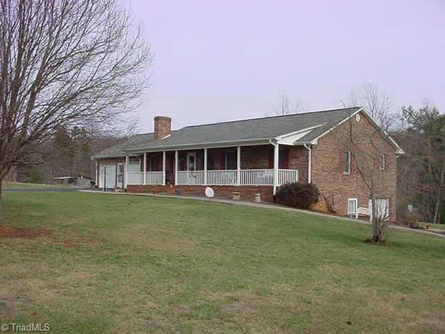4985 Whitman Road Pfafftown, NC 27040 - Photo 1 of 8 Exterior Front. Brick home with vinyl eaves, w/49 front porch with swing