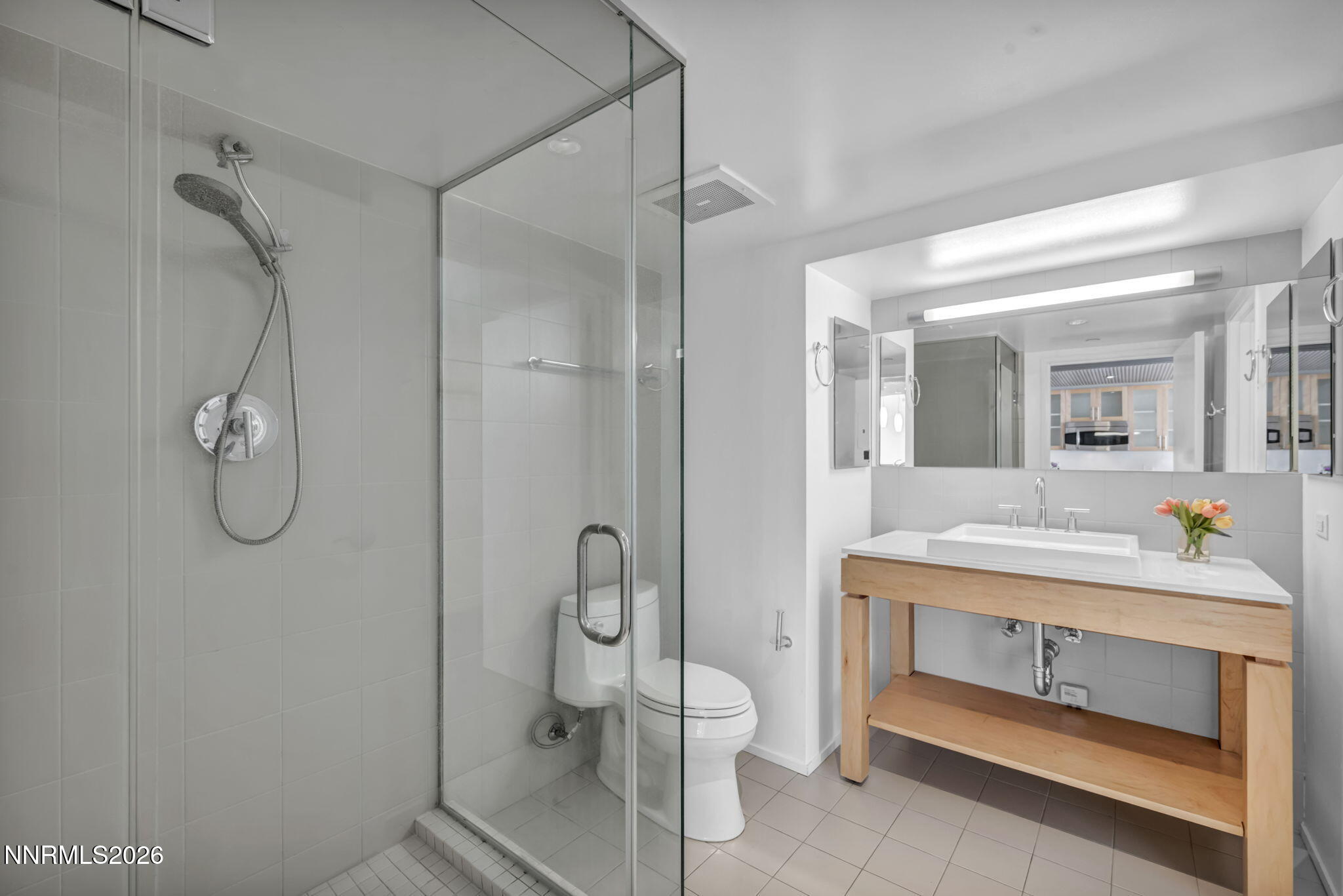 255 North Sierra Street, Unit 1208 Reno, NV 89501 - Photo 22 of 37 a bathroom with a sink mirror vanity and toilet