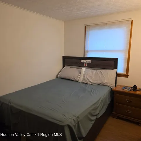 a bedroom with a bed and a night stand