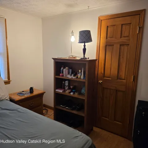 a bedroom with a bed and a bookshelf