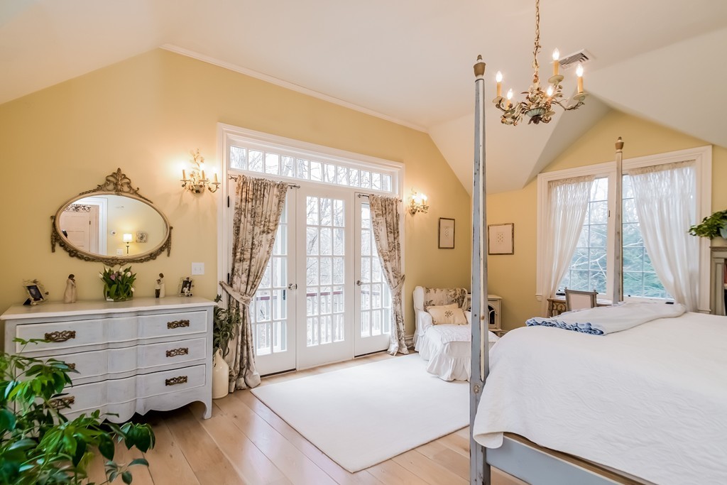 489 Bay Road Hamilton, MA 01982 - Photo 18 of 30 a bedroom with a large bed and a chandelier