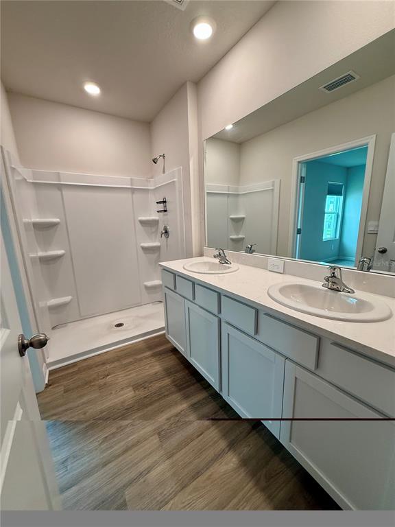 3222 Bitterroot Lane Bradenton, FL 34211 - Photo 22 of 34 a spacious bathroom with a double vanity sink a mirror and a bathtub