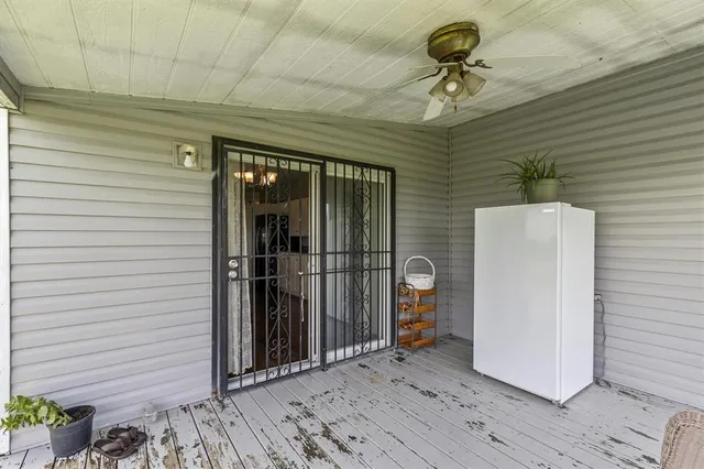 a view of a livingroom with a walk in closet and balcony